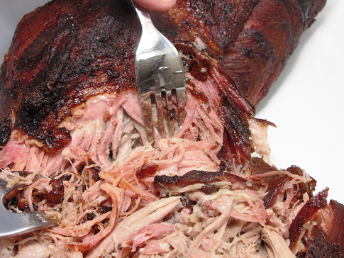 smoked pork butt/shoulder being shredded with forks